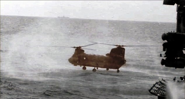 Nguyen hovering his Chinook over the water while he removes his clothes
