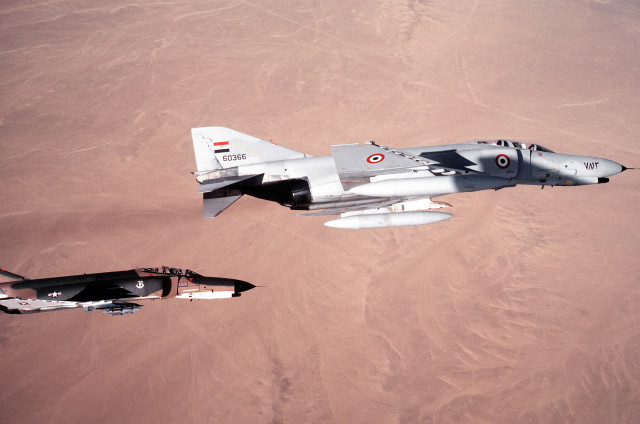 An air-to-air right side view of an Egyptian air force F-4E Phantom II aircraft in formation with a 347th Tactical Fighter Wing F-4E aircraft during exercise PROUD PHANTOM.