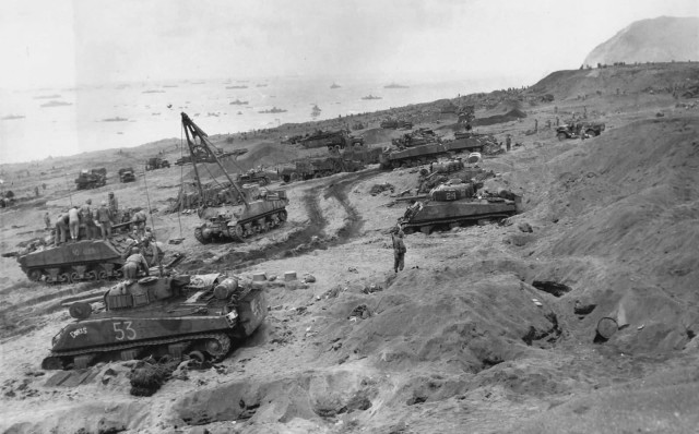 M4_Sherman_tanks_Equipment_for_Battle_coming_ashore_Iwo_Jima_3_February_1945