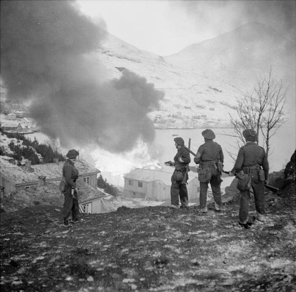 Commandos watching a burnig munitions dump