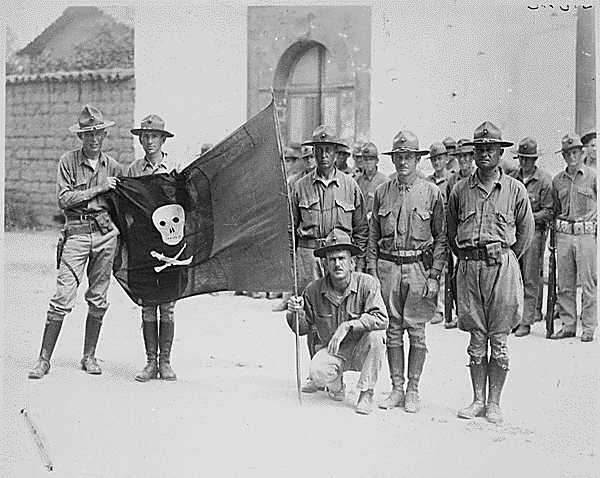 Marines holding a captured flag of the Sandino forces via commons.wikimedia.org