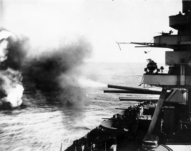 The battleship USS New York firing its 14 in (360 mm) main guns on the island, 16 February 1945 (D minus 3)