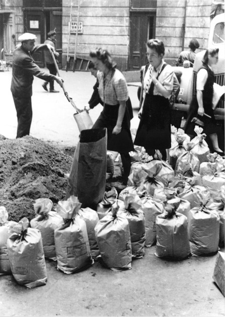 Warsaw residents stacking sand bags on Moniuszki Street, August 1944