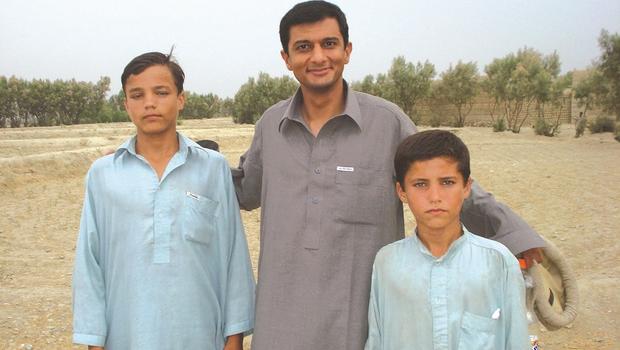 Dilip Joseph (center) in Afghanistan via http://www.cbsnews.com/pictures/dr-dilip-josephs-journey-kidnapped-by-the-taliban/6/