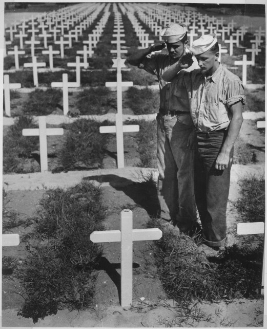 Two U.S. Coast Guardsmen pay homage to their comrade killed in the Ryukyu Islands.