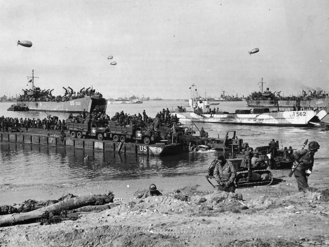 111th Naval Construction Battalion Landing at Omaha Beach D-Day Normandy 1944. LCT-562 and USS LST-502 in the background