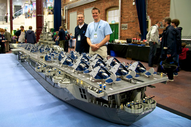 USS Intrepid (by Ann Diment, Ed Diment (right), Ralph Savelsberg (left)) USS Intrepid is a US Navy aircraft carrier that served from World War 2 until 1974 and is now a museum in New York. This Lego model of the ship is to the scale of Minifigs (Lego people). It is nearly 7m long, weighs 250kg, needed 250,000 bricks to build and took three people (with a number of other helpers) over 9 months to build