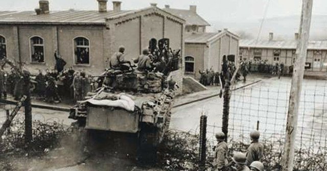 An M4 medium tank of the 47th Tank Bn., 14th Armored Division crashes into the prison compound at Oflag XIII-B, 6 April 1945 two weeks after the failed Task Force Baum raid.