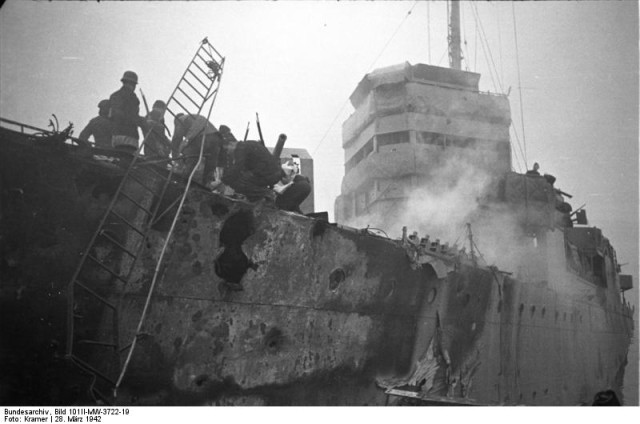 Close up of HMS Campbeltown after the raid. Note the shell damage in the hull and upper works and the German personnel on board the vessel.