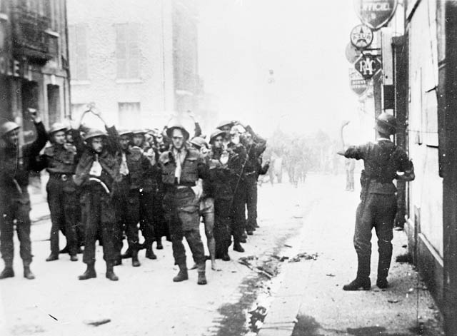 Canadian prisoners of war being lead through Dieppe by German soldiers.