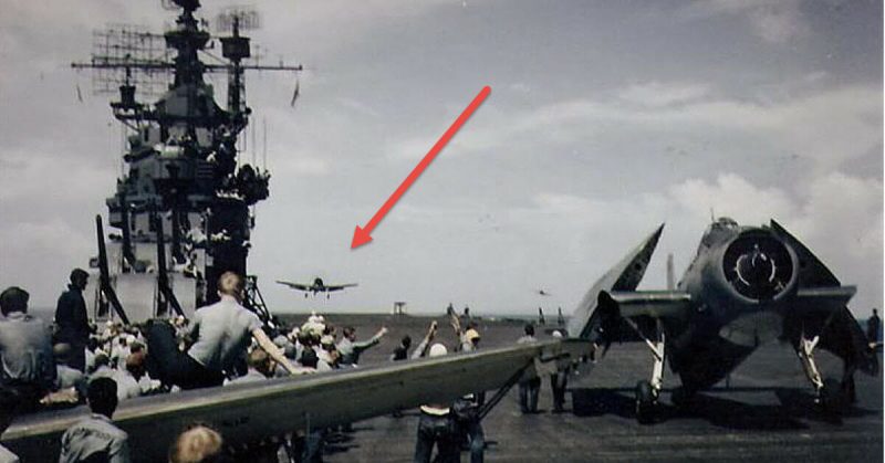 Aircraft return to the carrier during the Gilberts operation, November 1943. Crewmen in the foreground are sitting on the wing of an SBD-5, as an F6F-3 lands and a TBF-1 taxis to a parking place on the forward flight deck.