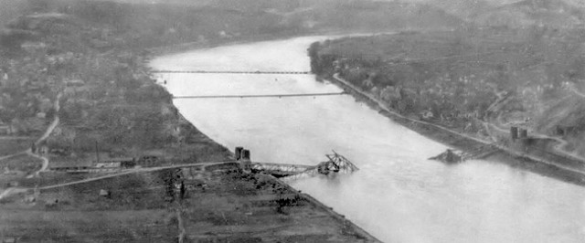 An aerial view of the Ludendorff Bridge after it collapsed on 17 March 1945. Two treadway pontoon bridges are visible to the north.