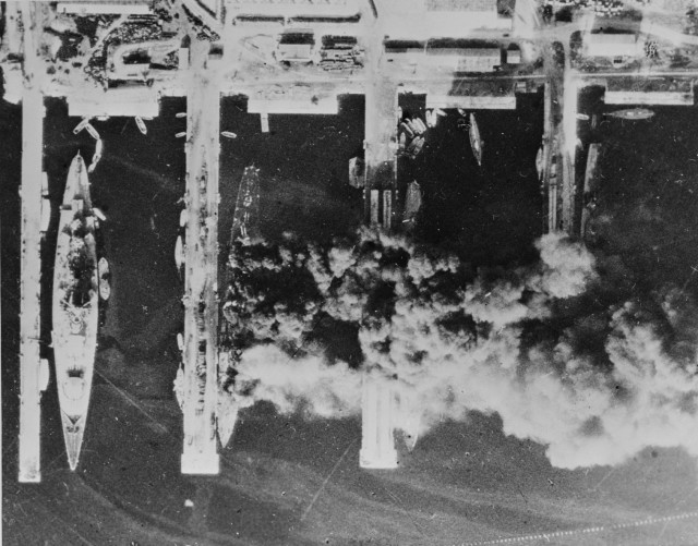 The scuttled French fleet at Toulon: aerial pictures. On 28 November 1942, the day after the scuttling and firing of the ships of the French fleet in Toulon harbour, photographs were taken by the Royal Air Force. Many of the vessels were still burning so that smoke and shadows obscure part of the scene.