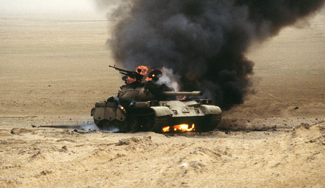 An Iraqi T-55 main battle tank burns after an attack by the 1st United Kingdom Armored Division during Operation Desert Storm.