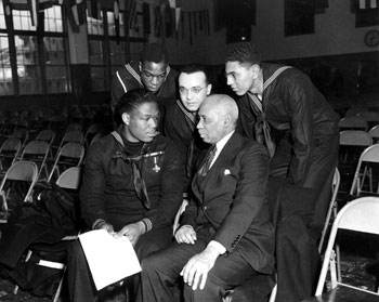 Miller speaking with sailors and a civilian at Naval Station Great Lakes, January 7, 1943.