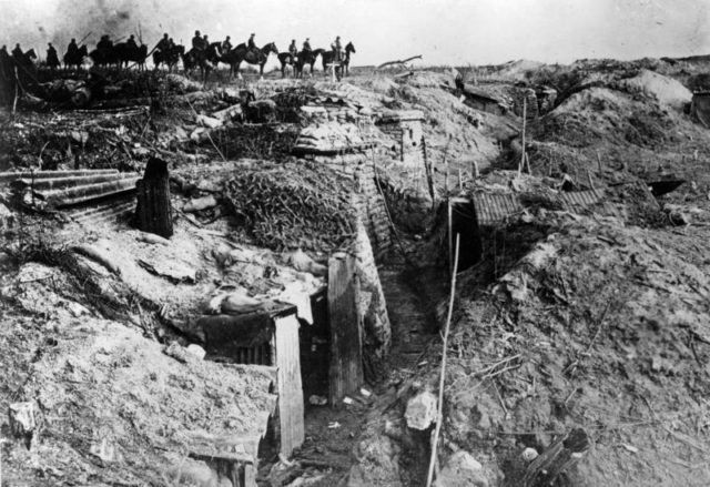 Germans passing a captured British trench. Photo Credit.