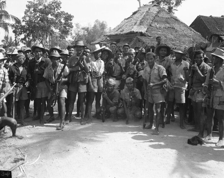 Filipino guerrillas standing together in the middle of a village