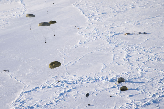 More than 12,000 pounds of cargo fall out of the back of a C-17 Globemaster III over the Arctic Ocean in support of the U.S. Navy Submarine Forces' Ice Exercise 2016. ICEX 2016 is a five-week exercise designed to research, test and evaluate operational capabilities in the Arctic region. (U.S. Air Force photo by Staff Sgt. Sheila deVera)