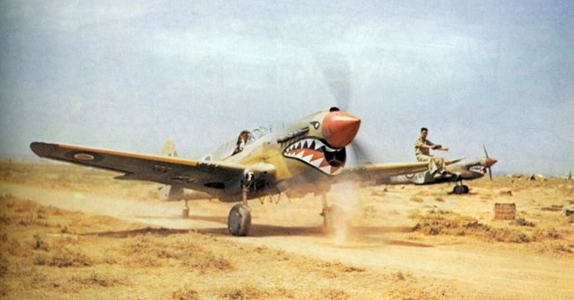 A Kittyhawk Mk III of No. 112 Squadron RAF, taxiing at Medenine, Tunisia, in 1943. A ground crewman on the wing is directing the pilot, whose view ahead is hindered by the aircraft’s nose.