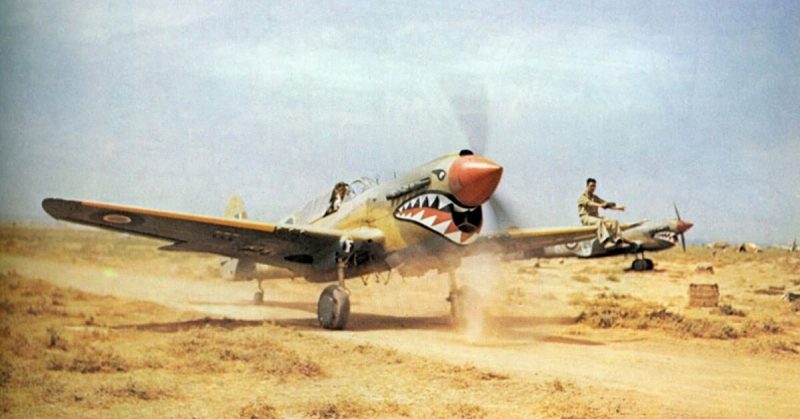 A Kittyhawk Mk III of No. 112 Squadron RAF, taxiing at Medenine, Tunisia, in 1943. A ground crewman on the wing is directing the pilot, whose view ahead is hindered by the aircraft's nose.