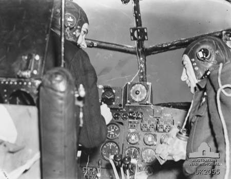 Inside G for George of No. 460 Squadron RAAF. Lancaster pilot at the controls, left, flight engineer at right. Photo Credit.