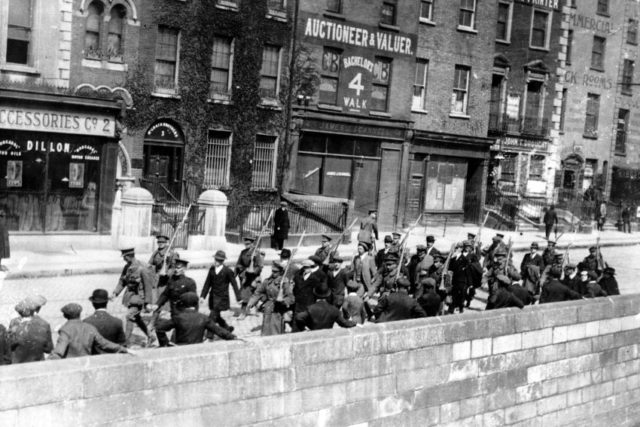 British soldiers marching rebel prisoners away after the surrender.