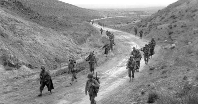 Men of the 2nd Battalion, 16th Infantry Regiment of the U.S. 1st Infantry Division march through the Kasserine Pass and on to Kasserine and Farriana, Tunisia February 26, 1943.