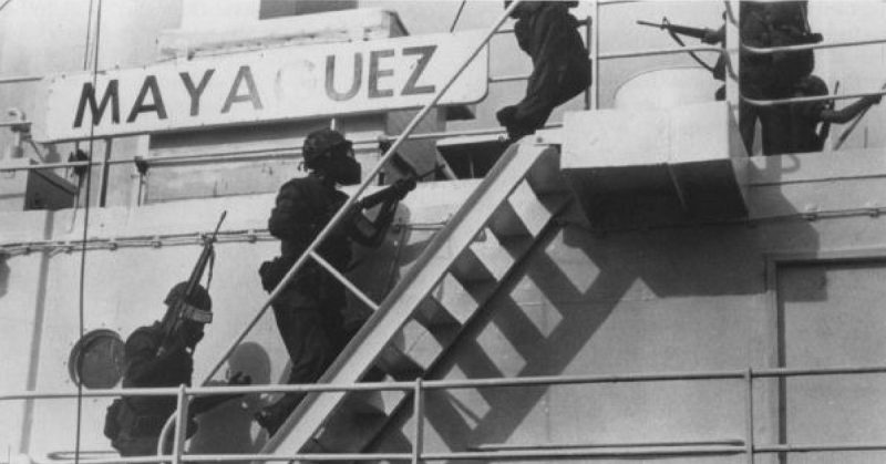 Members of Company D, 1st Battalion, 4th Marines board the Mayaguez. Gas masks were worn because the ship was bombed with tear-gas cannisters by the Air Force.