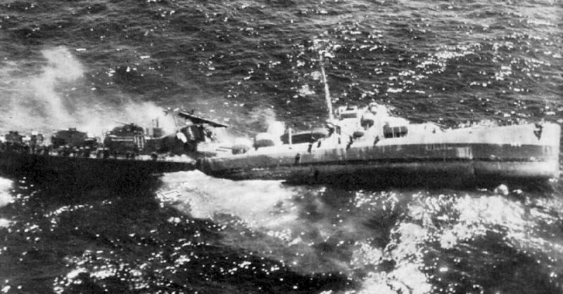 USS Fiske broken in two and sinking in the Atlantic Ocean on 2 August 1944 after she was torpedoed by the German submarine U-804. Note the men abandoning ship by walking down the side of her capsizing bow section.