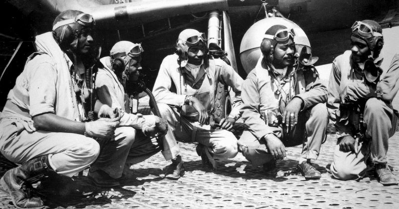 Pilots of the 332nd Fighter Group at Ramitelli Airfield, Italy; from left to right, Lt. Dempsey W. Morgan, Lt. Carroll S. Woods, Lt. Robert H. Nelron, Jr., Captain Andrew D. Turner, and Lt. Clarence P. Lester.