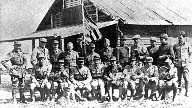 Standing (left to right) Soubiron, Doolittle, Campbell, Persons, Bridgman, Dugan, MacMonagle, Lowell, Willis, Jones, Peterson and de Maison-Rouge. Seated (left to right) Hill, Masson with "Soda," Thaw, Thenault, Lufbery with "Whiskey," Johnson, Bigelow and Rockwell.
