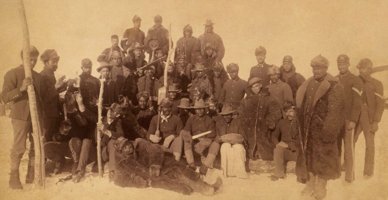 Buffalo soldiers of the 25th Infantry, some wearing buffalo robes, Ft. Keogh, Montana. By Chr. Barthelmess - Library of Congress CALL NUMBER: Unprocessed in PR 13 CN 1995:113.274 [item] [P&P]This image is available from the United States Library of Congress's Prints and Photographs division under the digital ID cph.3g06161.