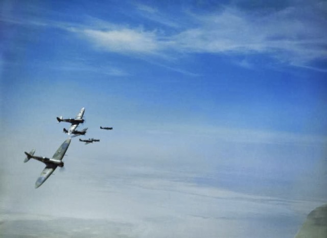 RAF Spitfires banking over Tunisia during a sortie, 1943. © IWM (TR 857)