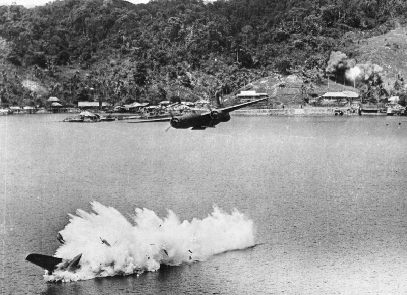 Two of twelve USAAF A-20 Havoc light bombers on a mission against Kokas (Western New guinea) in July of 1943. One bomber was hit by anti-aircraft fire after dropping its bombs, and plunged into the sea, killing both crew members. The low bomb runs were more accurate against shipping and harbor installations but became very risky. The Japanese had their highly effective 75 mm anti-aircraft guns, mostly well camouflaged, positioned in gun pits all around the harbors and airfields.