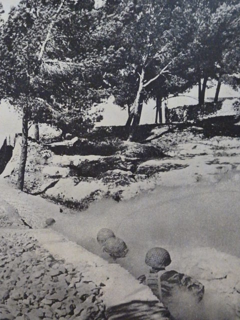 Israeli paratroopers flush out Jordanian soldiers from trenches during the Battle of Ammunition Hill.