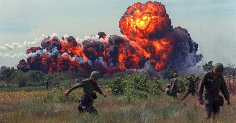 A napalm strike erupts in a fireball near U.S. troops on patrol in South Vietnam, 1966 during the Vietnam War.