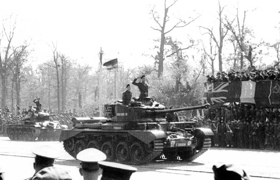 Comet Tank, with Chaffee behind it saluting during the parade. Tanks of the Desert Rats, they were the only ones to actually salute as they went past. The other nation's tank crews either turned their turrets or made no display. The 52 TAC sign denote it as 1st RTR.  (desertrats.org.uk)