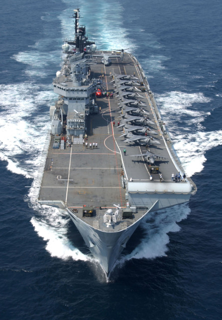 Fixed wing aircraft from the USMC arranged on Illustrious; ten AV-8B Harriers are lined up with, at the rear, an MV-22 Osprey