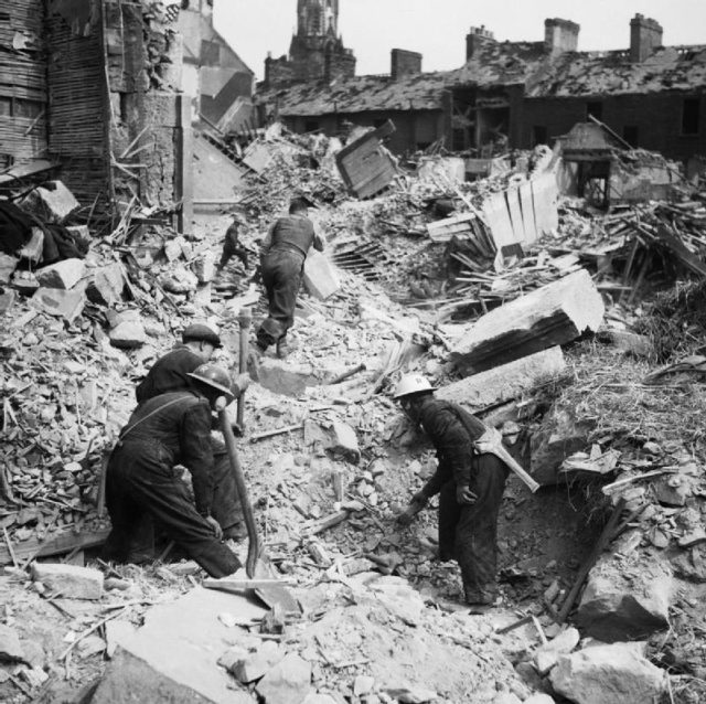 Rescue workers searching through rubble after an air raid on Belfast.