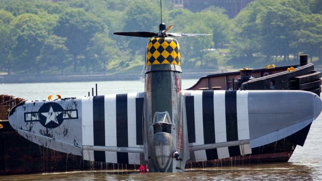 The World War II vintage P-47 Thunderbolt that crashed into the Hudson River Friday, May 27, 2016, is lifted from the water Saturday. The pilot, William Gordon, 56, of Key West, Fla., died in the crash. Photo Credit: Craig Ruttle 