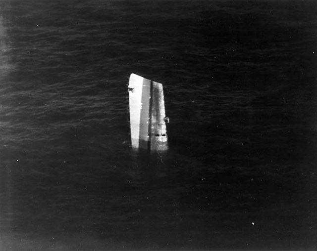 The bow of the USS Fiske floating in the North Atlantic after she was broken in two by a torpedo from the German submarine U-804 on 2 August 1944. This section had to be sunk by gunfire. Photographed from an airplane based on USS Wake Island; note the sonar dome on Fiske's keel.