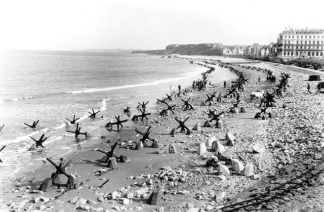 Czech hedgehog on the beach near Calais, Northern France and Field Marchall Rommel during inspection of defenses.