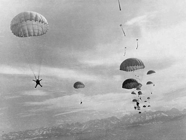 1960s. USSR Airborne drop in Fergana, Uzbekistan. Paratroopers jumped out from An-12.