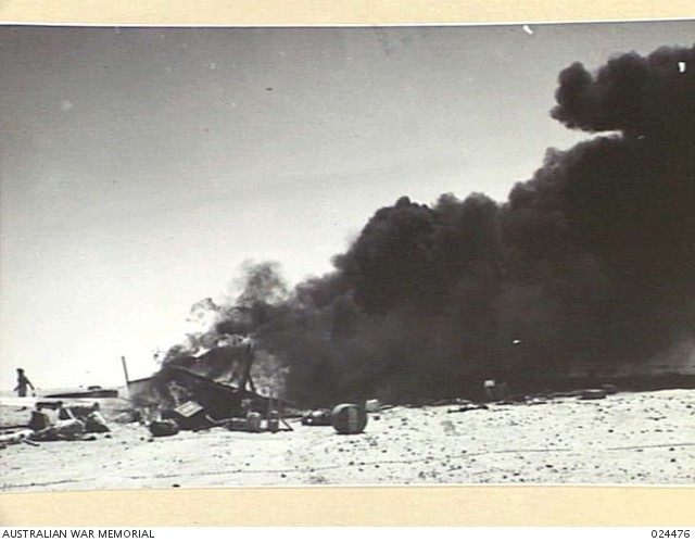 A Hurricane fighter-plane burning after it had been shot down near El Alamein. 7 July 1942 [via]