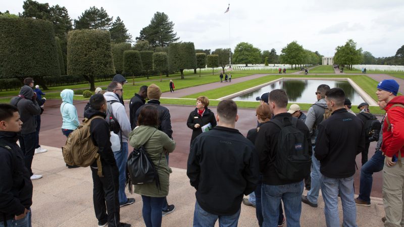 Marines from Headquarters and Service Battalion, Headquarters Marine Corps, Henderson Hall, Va., listen to a tour guide at the Normandy American Cemetery in Colleville sur Mer, France, May 25, 2016. More than 70 Marines traveled to France for a professional military education trip to learn about U.S. military history. Marine Corps photo by Sgt. Melissa Karnath