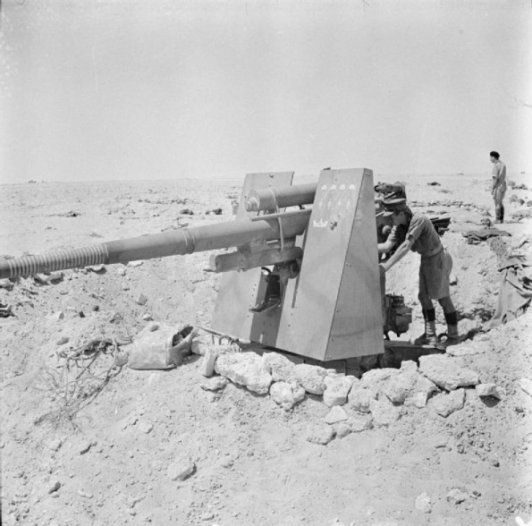 A soldier inspects a dug-in German 88mm anti-tank gun abandoned during the enemy retreat in the Western Desert. 24 July 1942