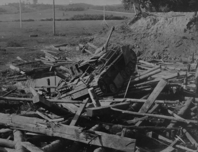 German StuG destroyed while driving across the bridge over Basya river. Attacked by Il-2. Mogilev, 22-28 June, 1944 [via]