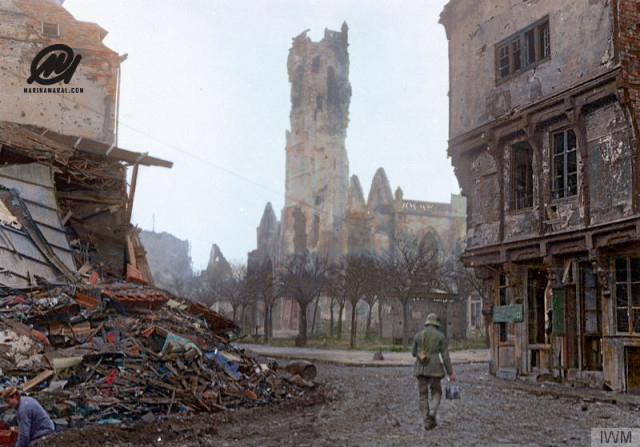 5b.German-soldier-with-a-telephone-wire-drum-in-shell-ruined-and-deserted-Peronne,-1916.