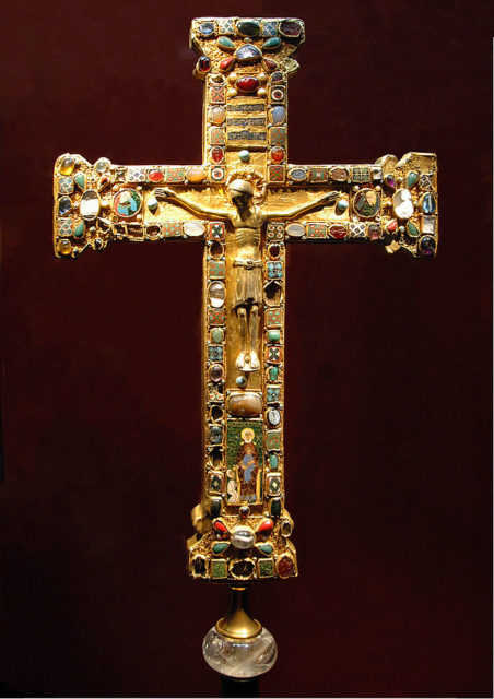 The Cross of Mathilde, a crux gemmata made for Mathilde, Abbess of Essen (973–1011), who is shown kneeling before the Virgin and Child in the enamel plaque. Photo Credit.