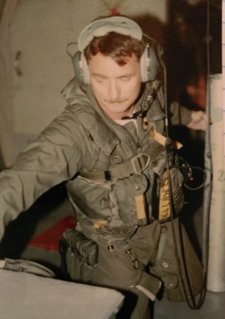 Elliott is pictured in the early 1980s loading a sonobouy while a member of the crew of a naval observation aircraft. Courtesy of Gary Elliott